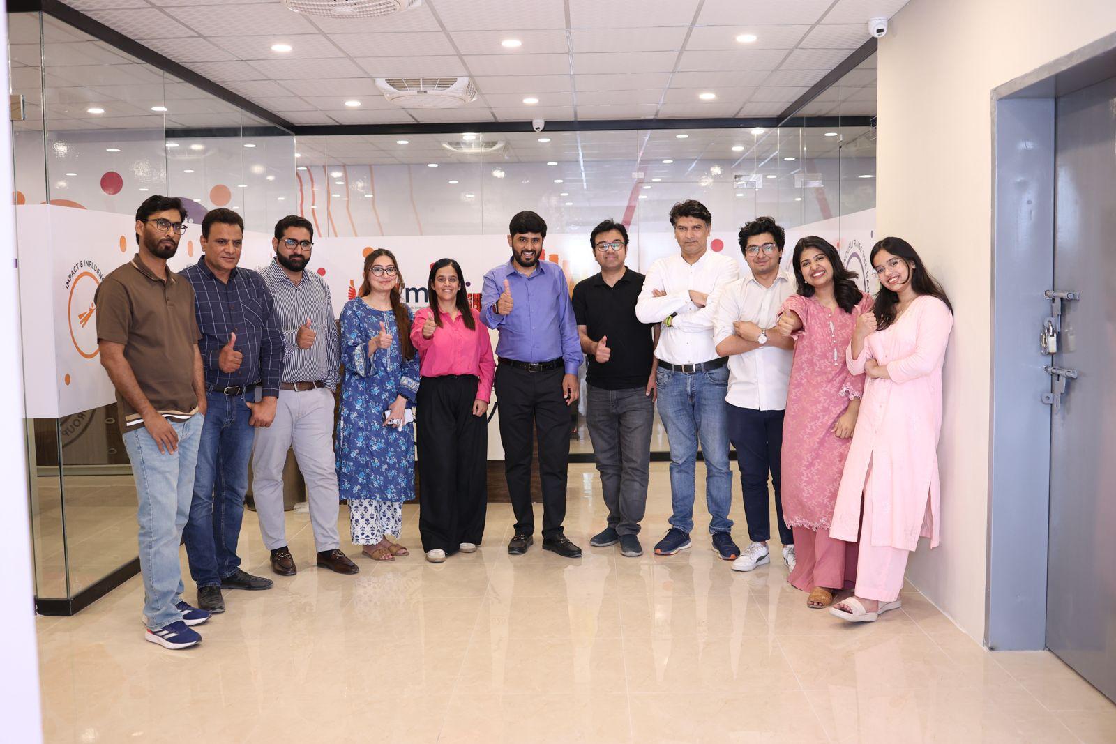 Barkat Group of Companies team members posing together at the office